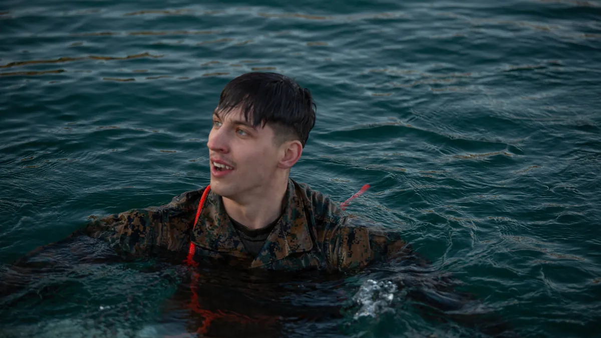 Service member chest-deep in cold water during an immersion training session